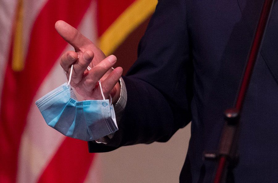 U.S. Senate Majority Leader Mitch McConnell, R-KY., holds a mask in hand as he addresses the media during a press conference at