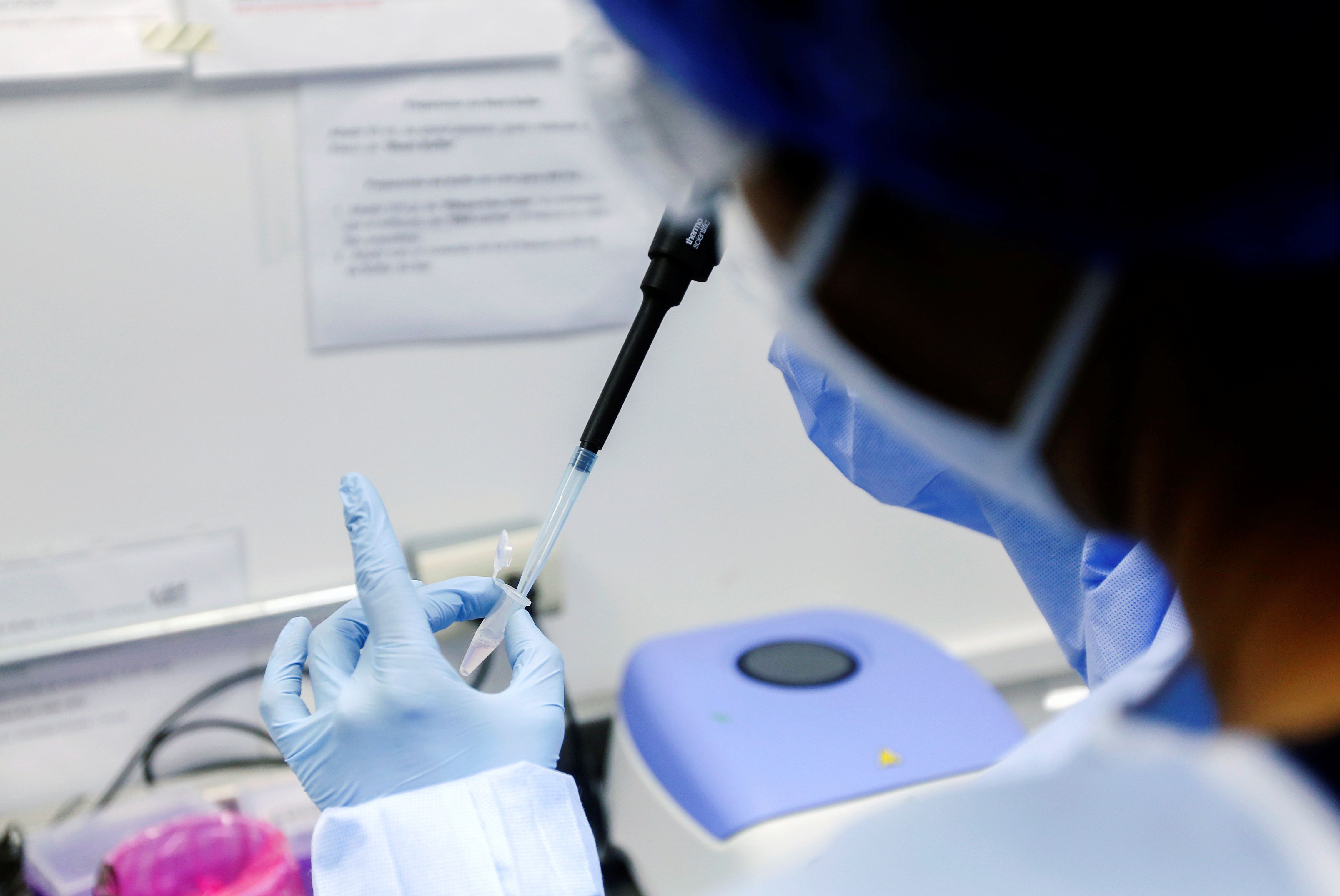 A lab technician performs a step in the testing procedure to investigate if a new strain of the coronavirus disease (COVID-19) detected in the state of Jalisco could be a Mexican variant of SARS-CoV-2, in Guadalajara