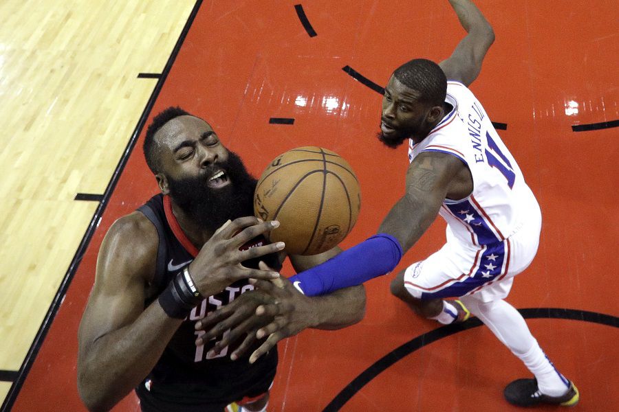 Houston Rockets' James Harden (13) is fouled by Philadelphia 76ers' J