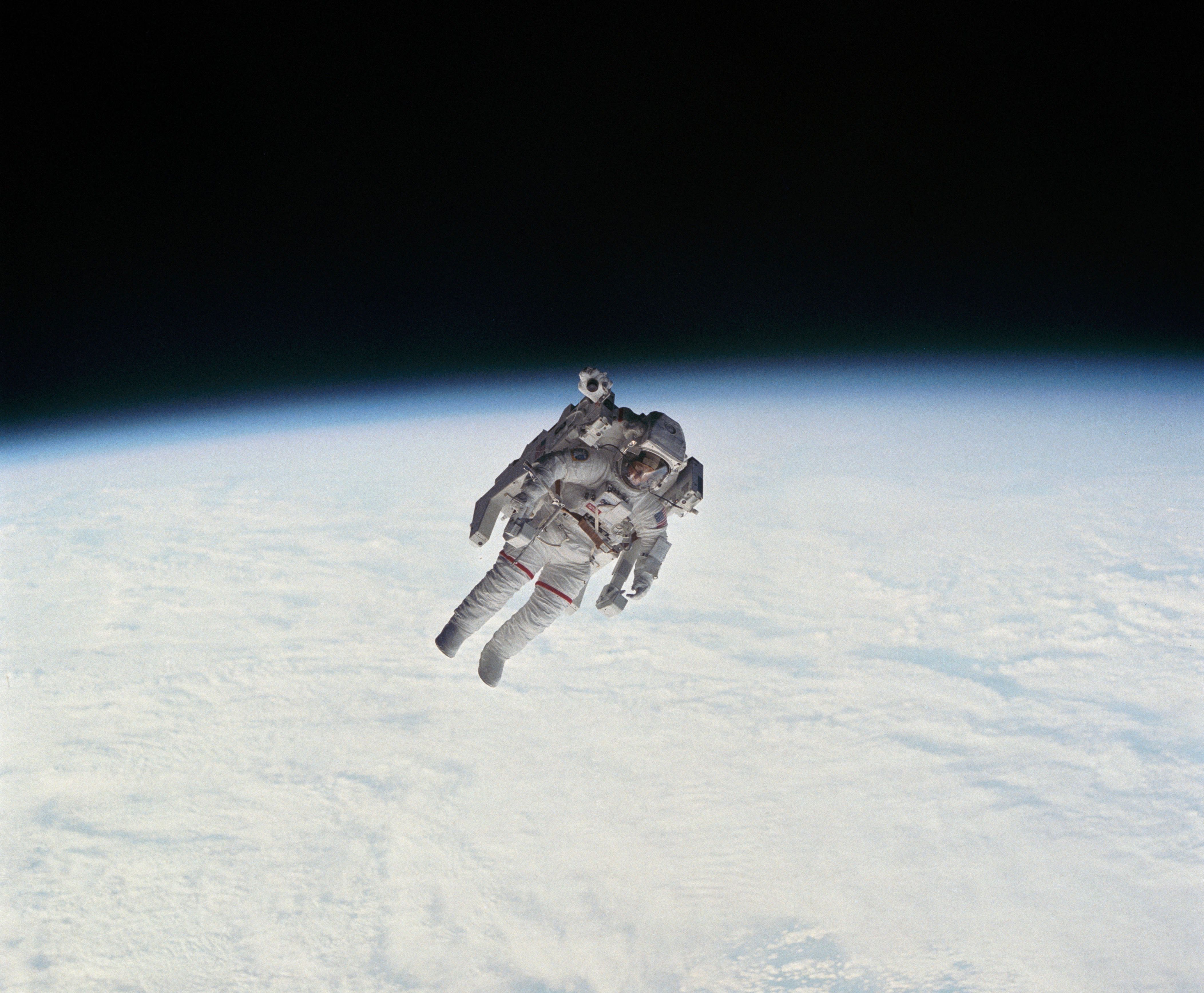astronauts floating in space shuttle