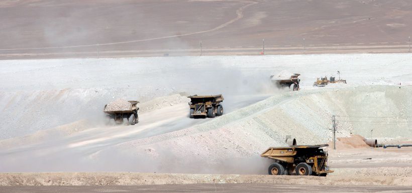 FILE PHOTO - Trucks travel along a road at Escondida, the world's biggest copper mine, in Antofagasta,