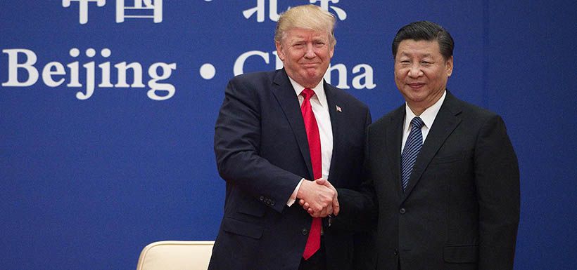 US President Donald Trump (L) and China's President Xi Jinping shake