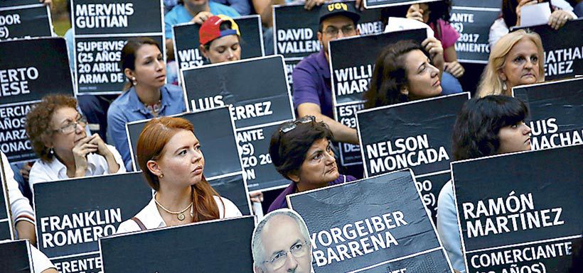 people-hold-placards-at-a-rally-to-pay-trib-38926316