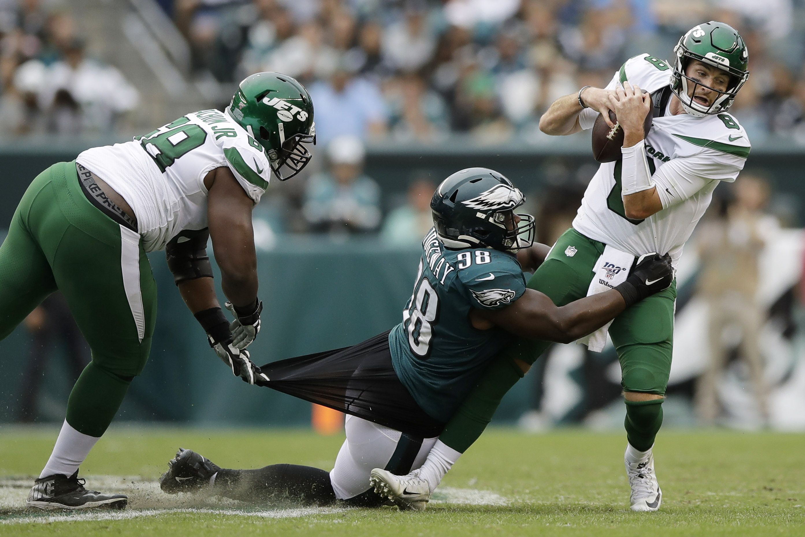 Philadelphia Eagles players react after they tackle New York