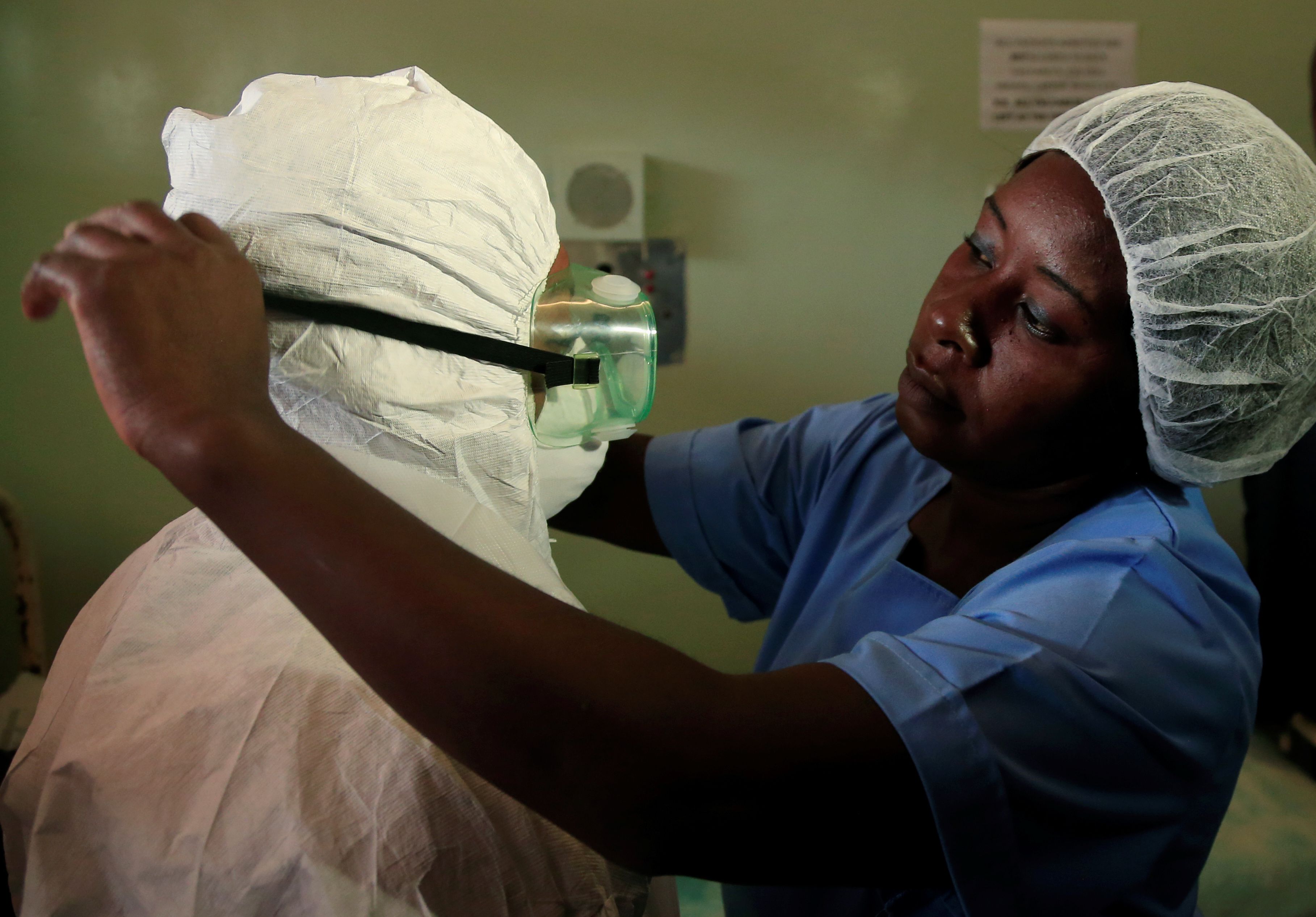 A health worker wears a protective suit during a demonstration of preparations for any potential coronavirus cases at a hospital in Harare