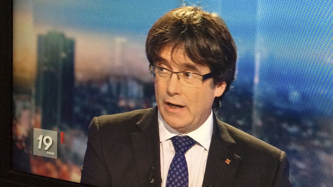 Ousted Catalan President Carles Puigdemont appears on a monitor during a live TV interview in Brussels