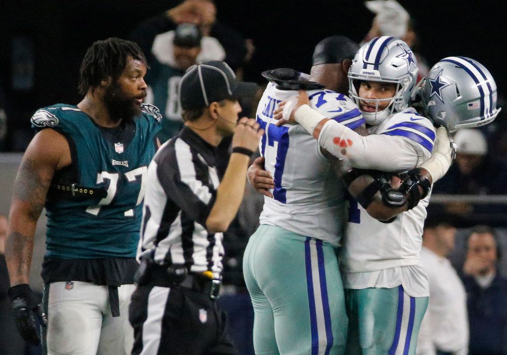 Dallas Cowboys quarterback Dak Prescott (4) alongside Tyron Smith