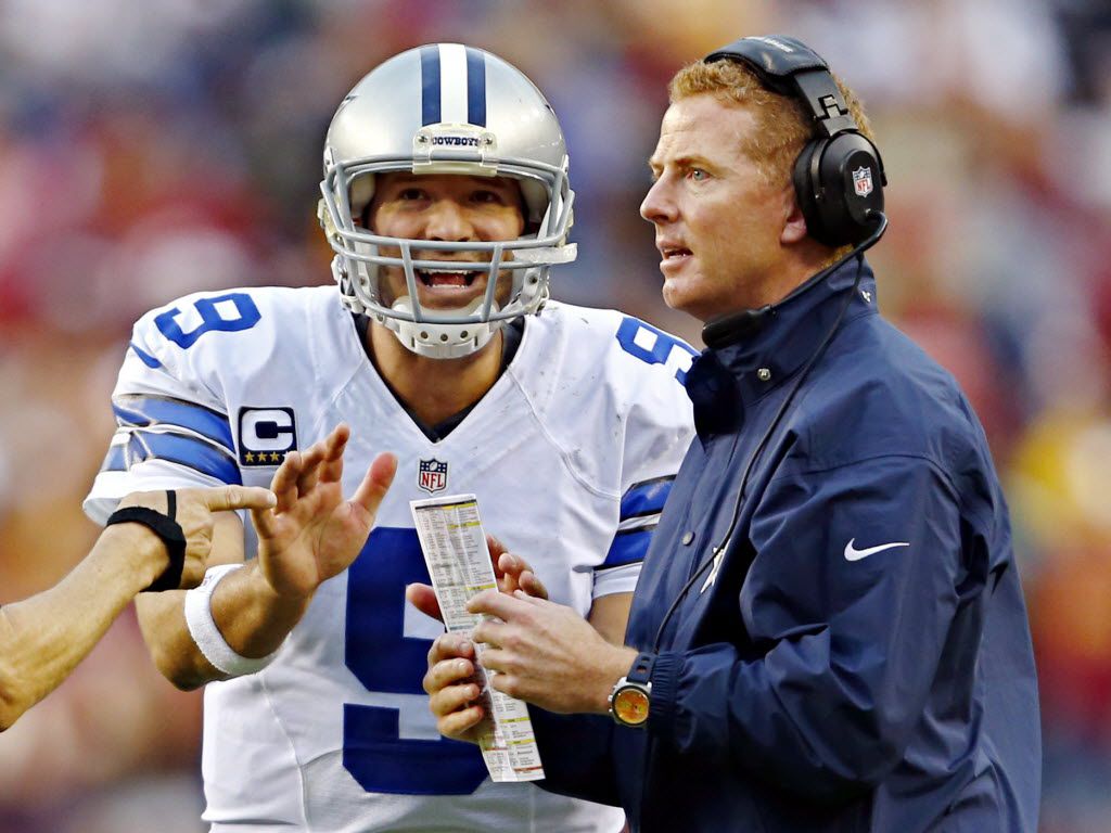 Dallas Cowboys offensive coordinator Jason Garrett (R) talks to quarterback  Tony Romo late in the fourth quarter against the Denver Broncos at Invesco  Field at Mile High in Denver on October 4