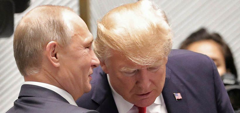 U.S. President Donald Trump and Russian President Vladimir Putin talk before a session of the APEC summit in Danang