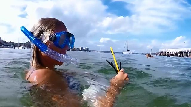 A powerful underwater shot of a plastic straw lodged in the