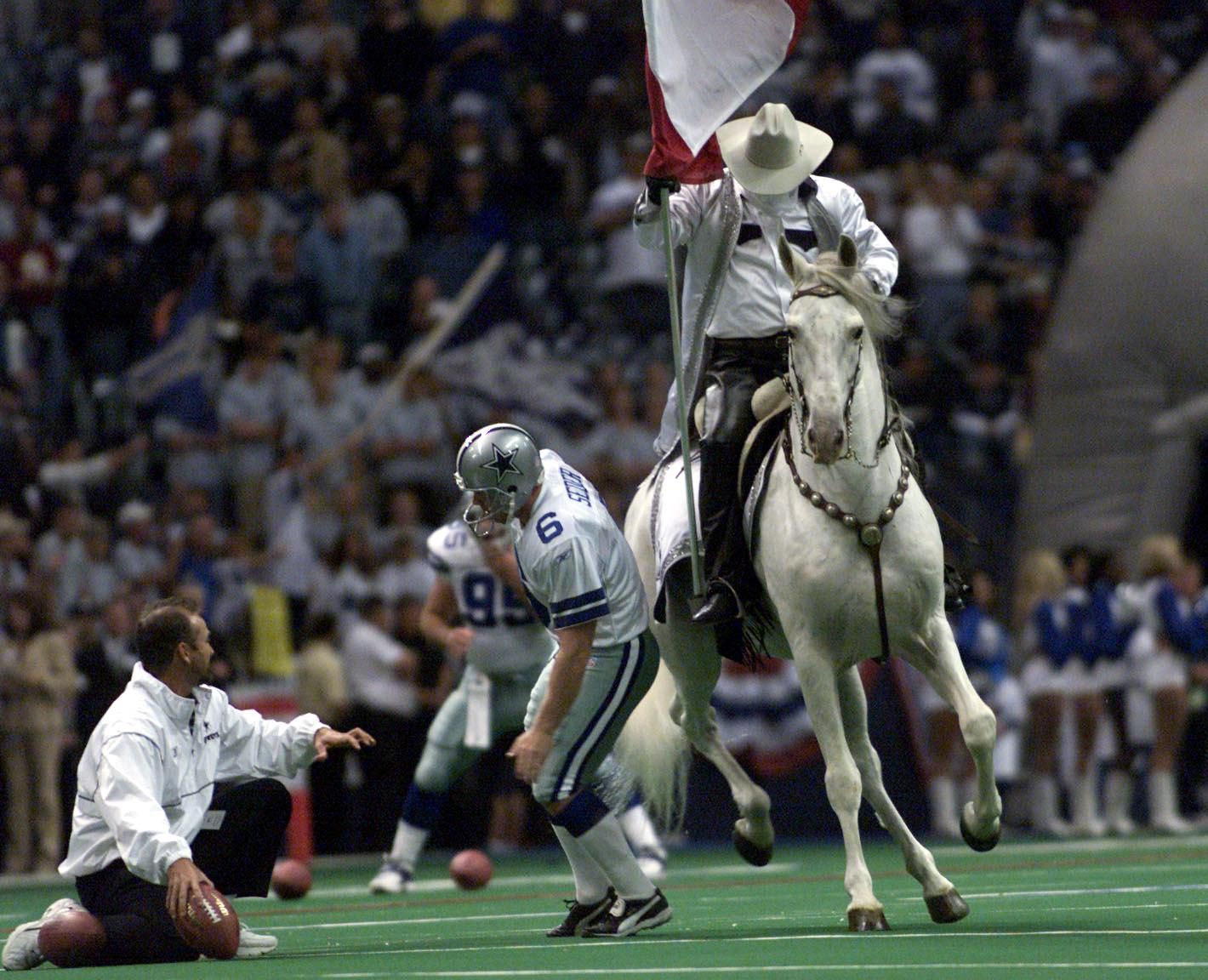 Dallas Cowboys' and Denver Broncos' kickers and other special-teams  players warm up prior to a National Football League game at the Cowboys'  home field AT&T Stadium in Arlington, Texas