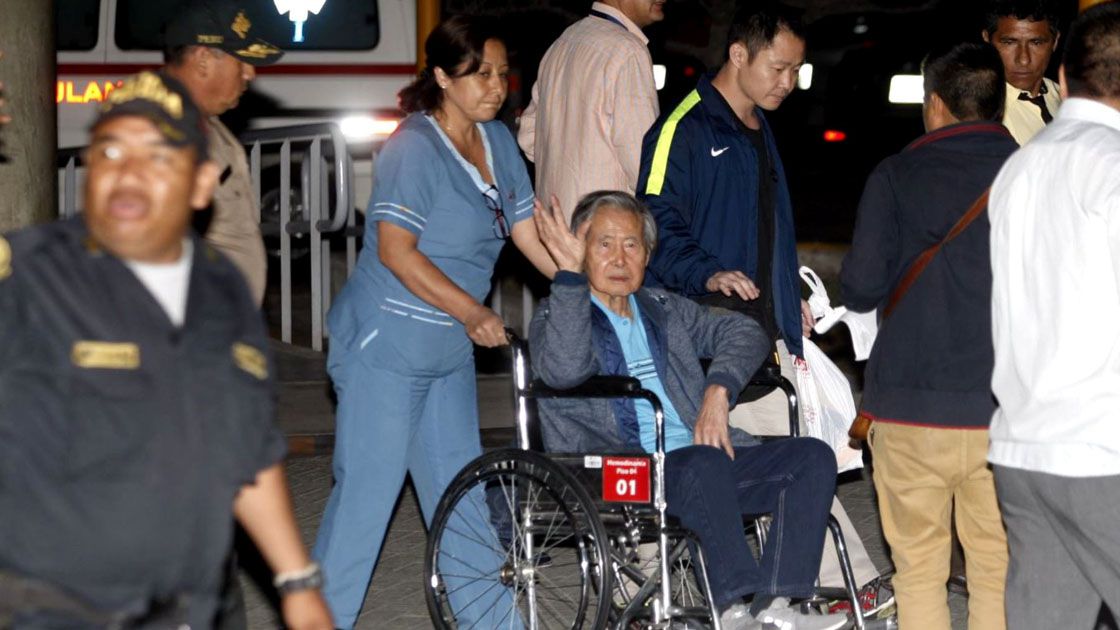 Former Peruvian President Alberto Fujimori accompanied by his son Kenji Fujimori leaves the Centenario hospital in Lima