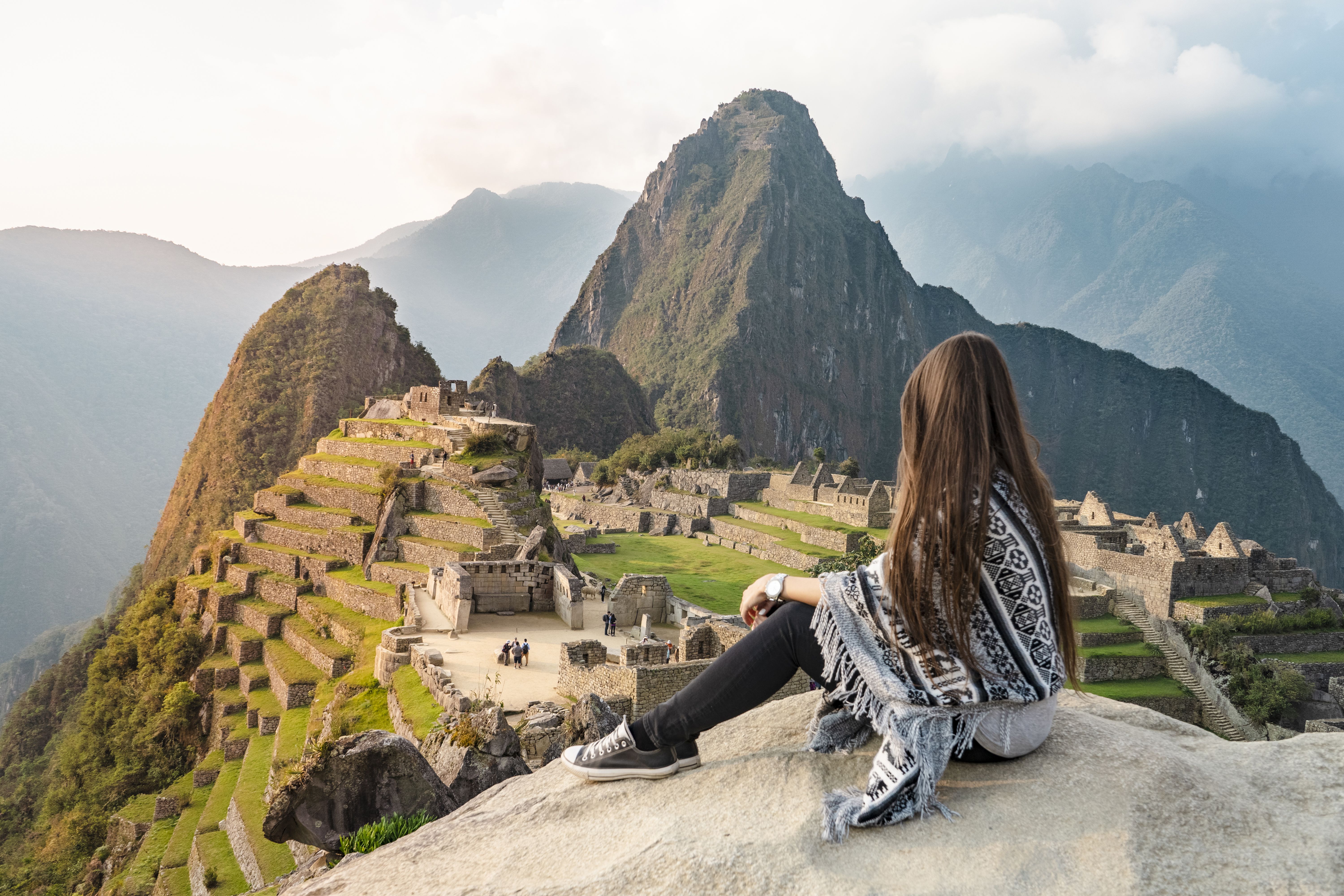 Girl sitting in front of Machu Picchu Peru, South America