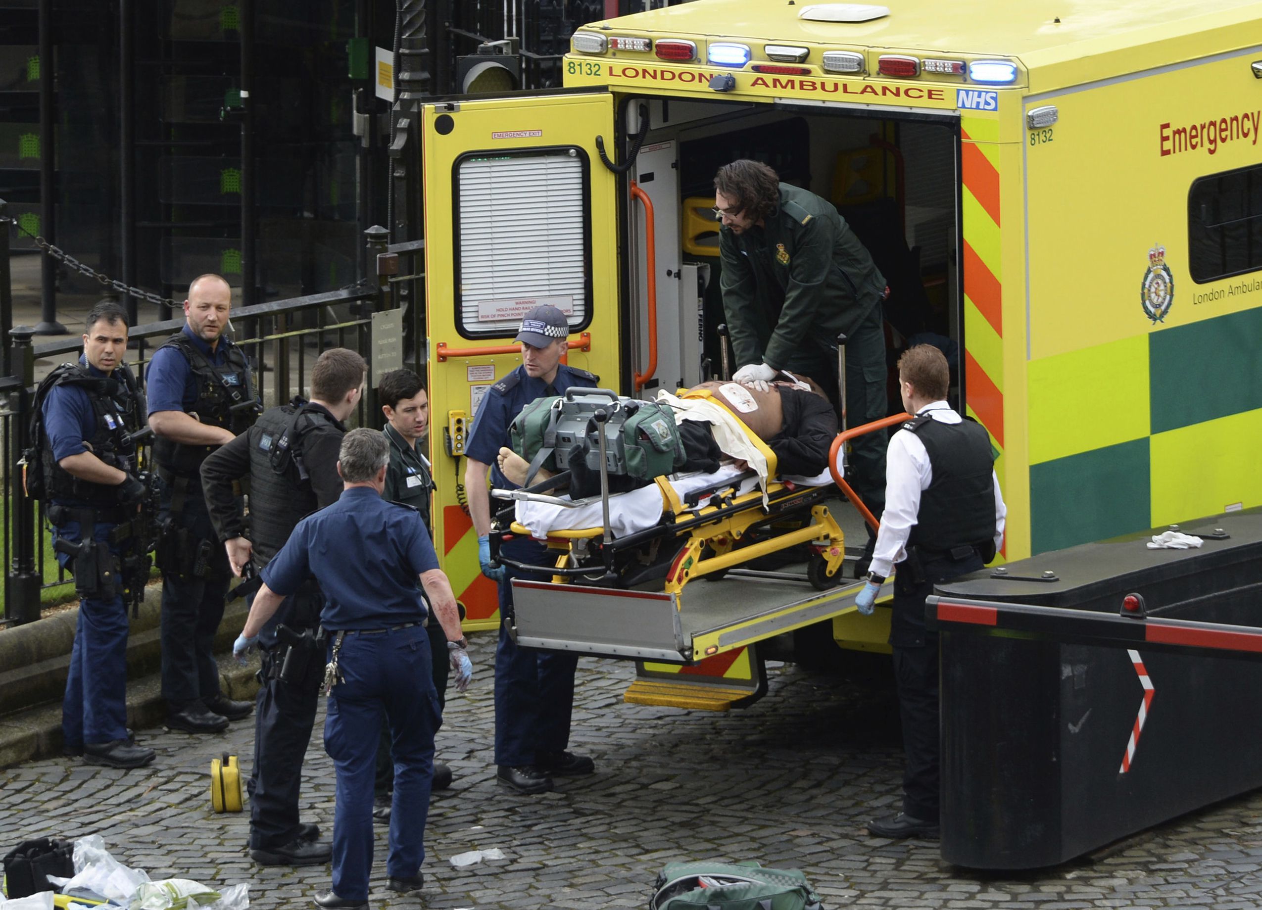 An attacker is treated by emergency services outside the Houses of Pa