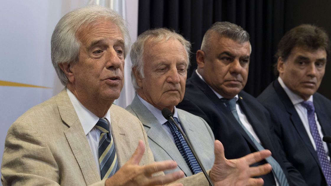 Uruguay's President Tabare Vazquez (L) delivers a speech listened by