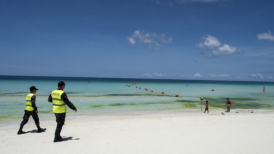 Policemen patrol on the beach on Philippine island of Boracay on Apri