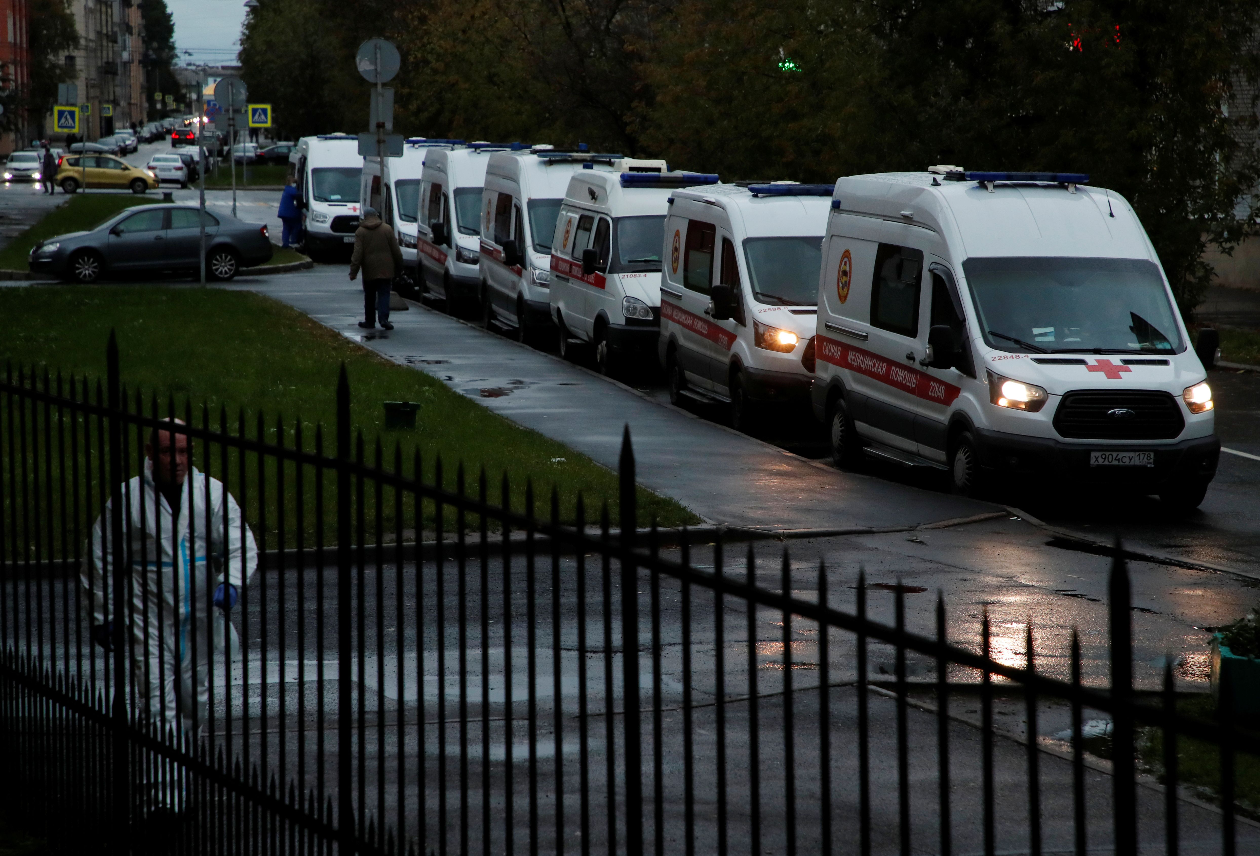 Ambulances queue before driving onto the territory of a hospital in Saint Petersburg