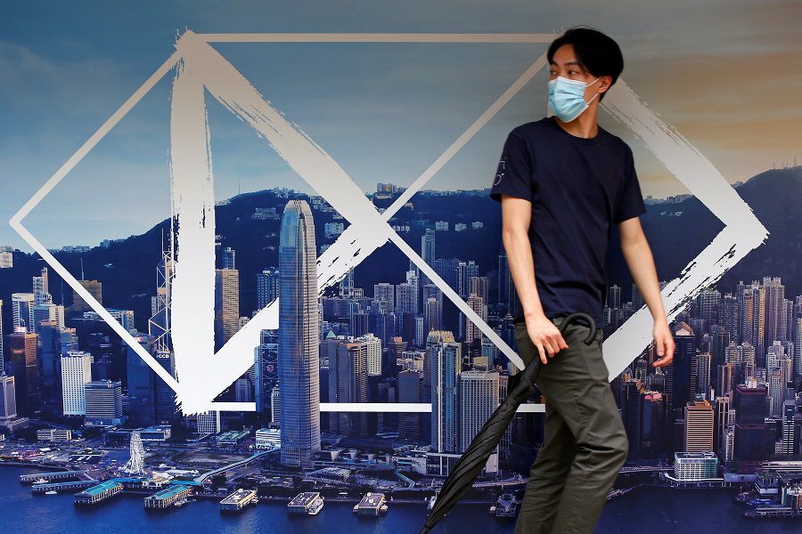 Pedestrian walks past an advertisement by HSBC at the financial Central district in Hong Kong