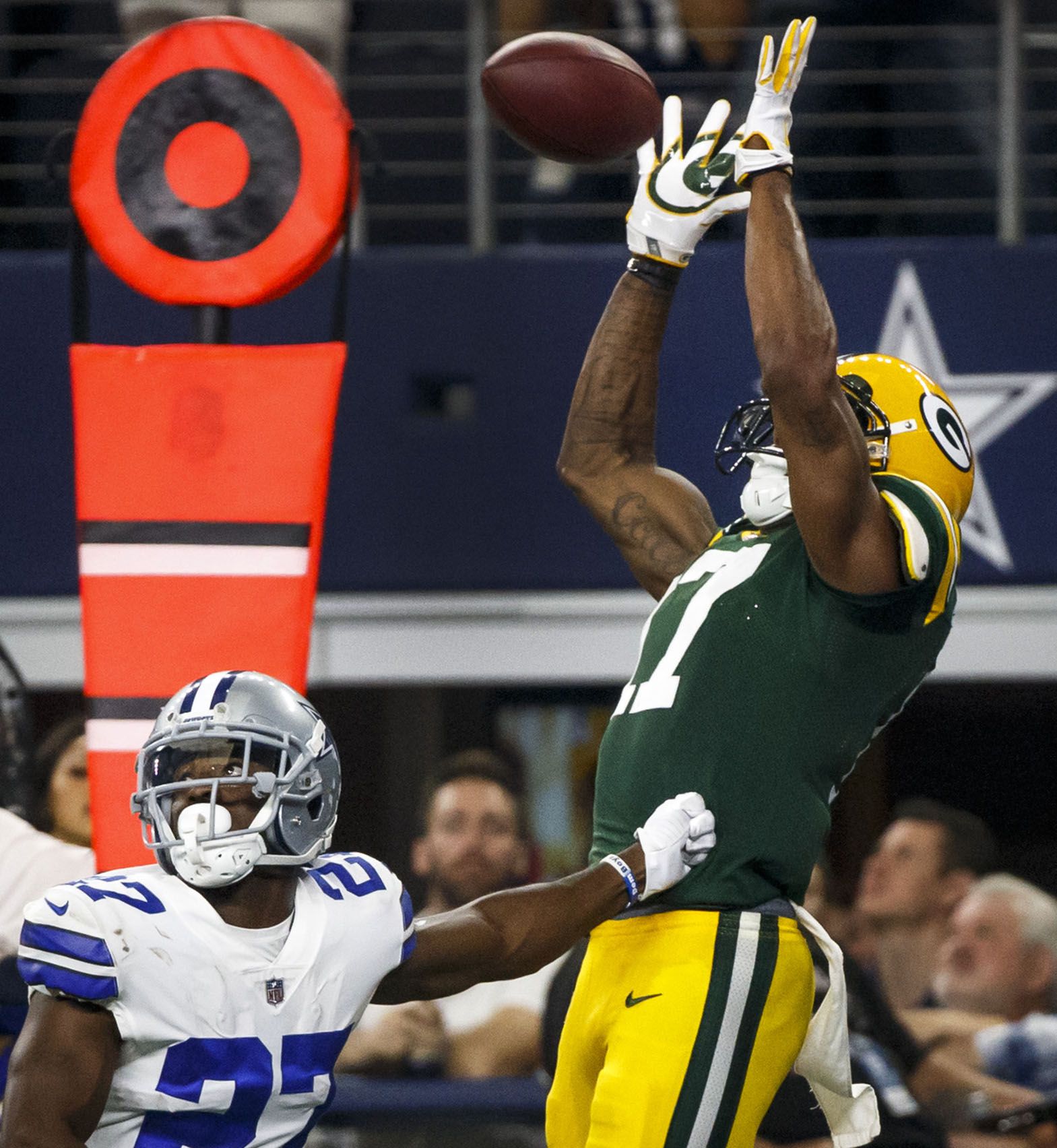 Oct 8, 2017; Arlington, TX, USA; Green Bay Packers quarterback Aaron Rodgers  (12) scrambles away from Dallas Cowboys defensive end Damontre' Moore (58)  in the third quarter at AT&T Stadium. Ma …