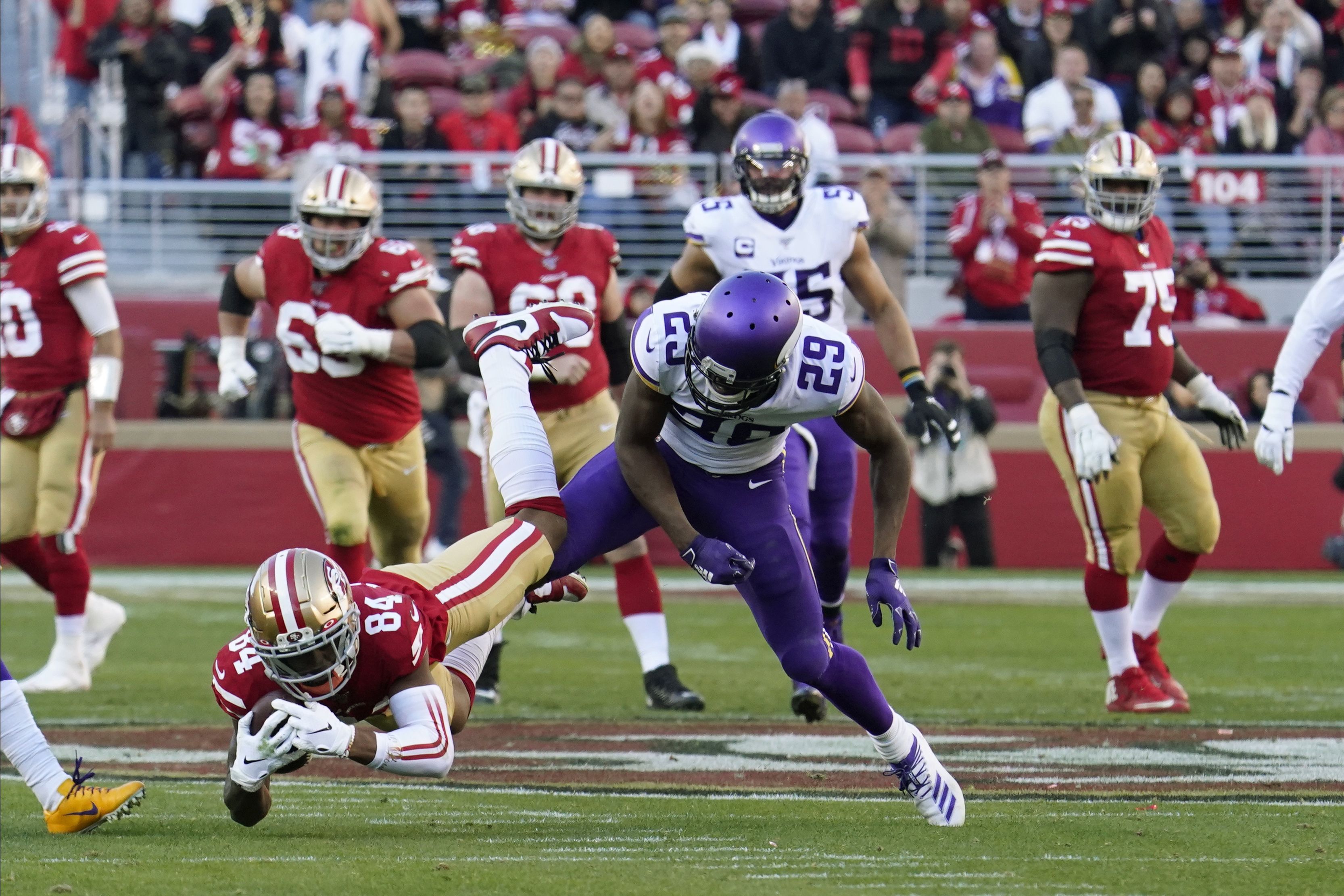 San Francisco 49ers wide receiver Deebo Samuel (19) runs in front of  Minnesota Vikings free safety Harrison Smith (22) during an NFL divisional  playoff game, Saturday, Jan. 11, 2020, in Santa Clara