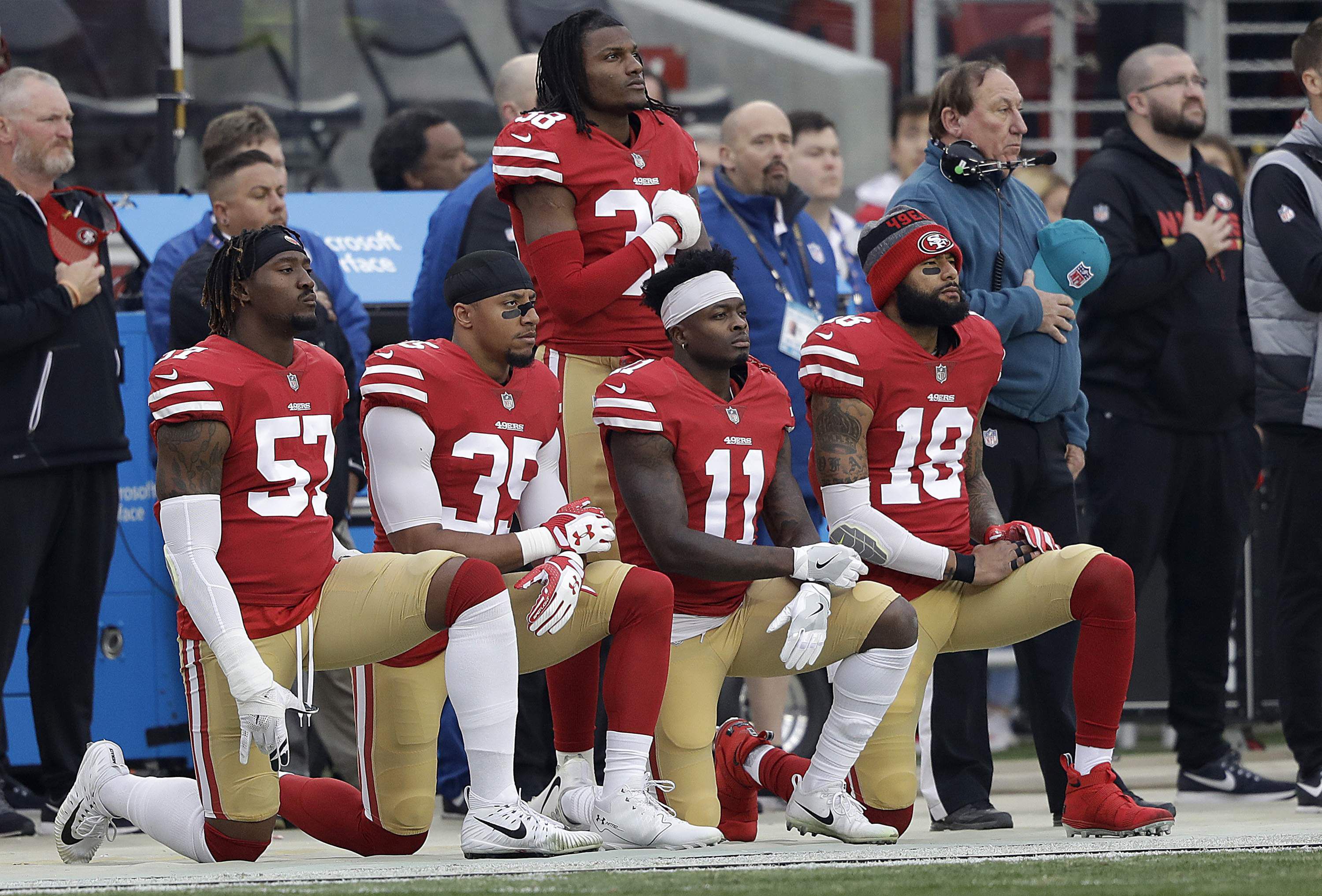 More than 200 NFL players sit or kneel during anthem