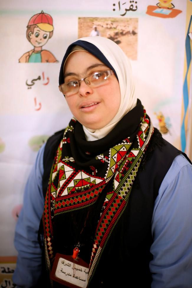 Hiba Al-Sharfa, a twenty seven-year-old Palestinian teacher aide with Down Syndrome poses for a photograph in a school at the Right to Live Society in Gaza City