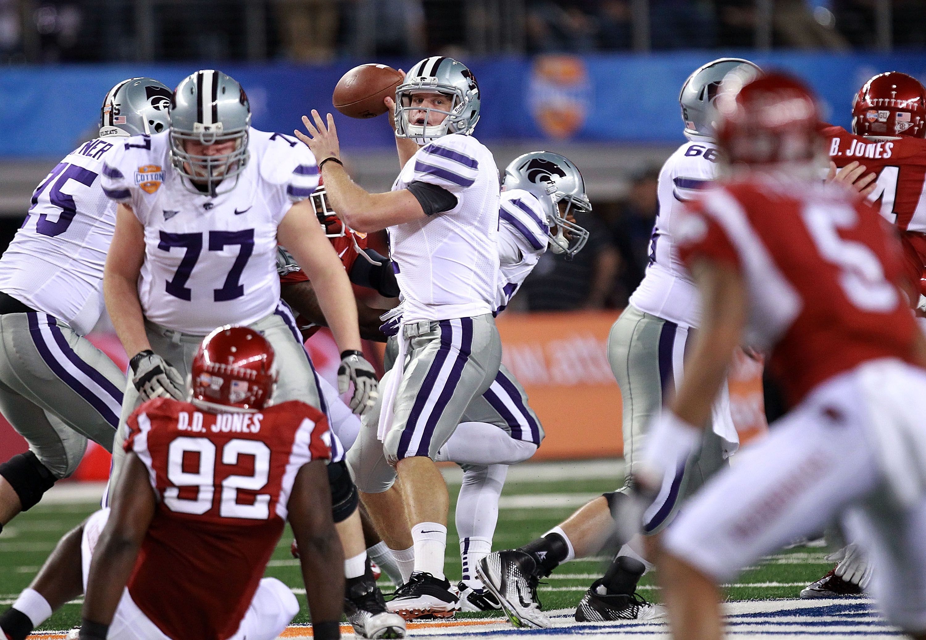 Andre McDonald (18) of Kansas State pulls in a touchdown pass late the  first half as Jake Bequette of Arkansas defends in the Cotton Bowl at  Cowboys Stadium in Arlington, Texas, on