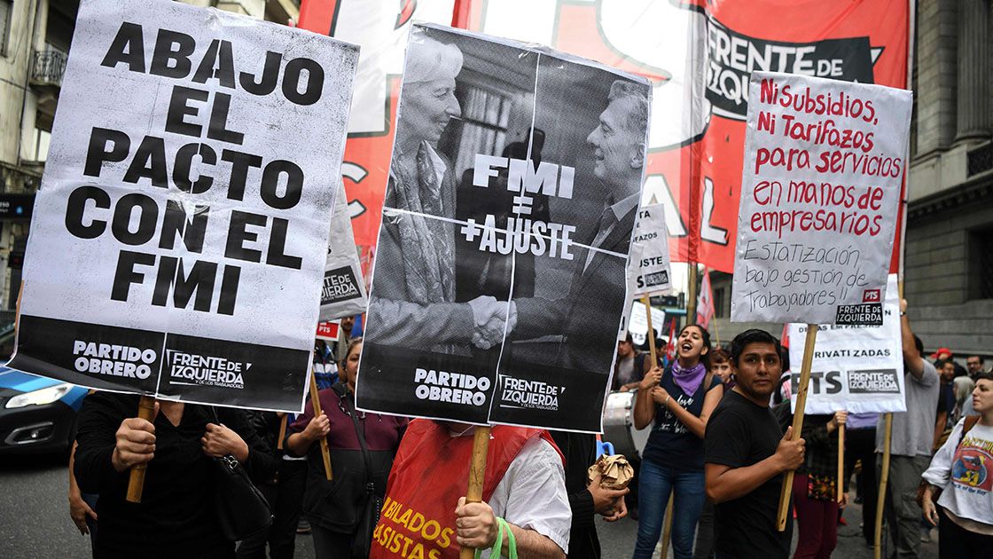 Members of leftist organizations hold banners against the government'