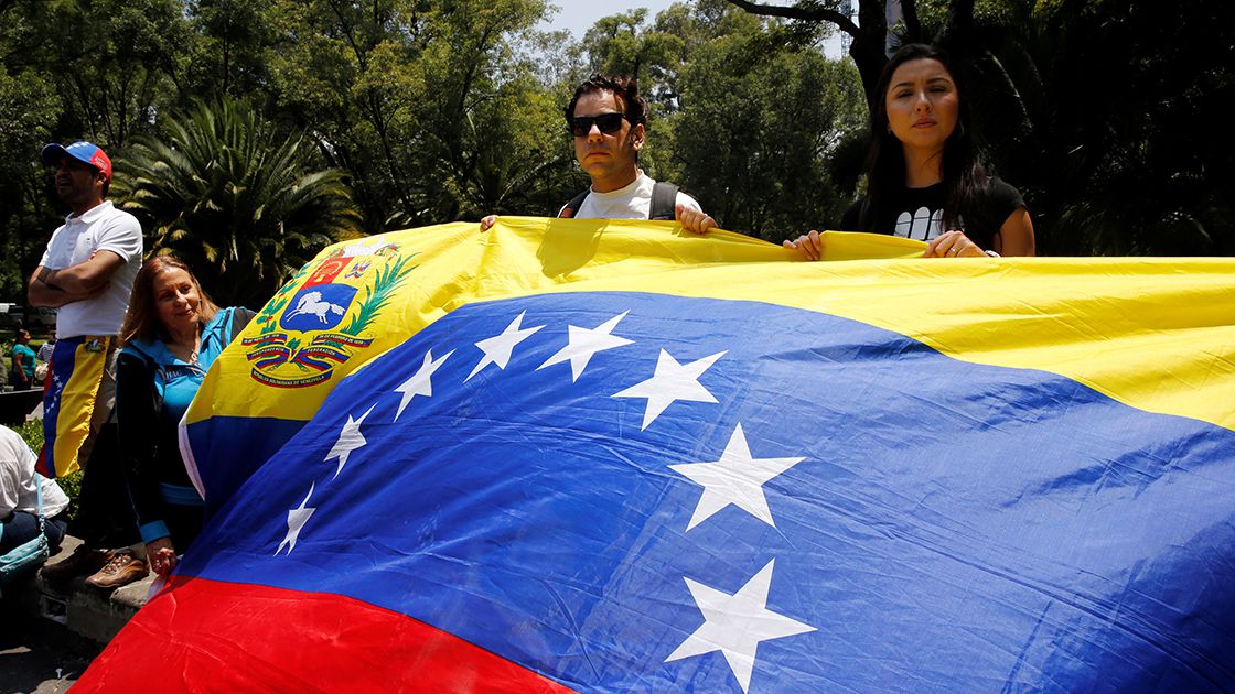 Franco Tintori holds a Venezuelan flag during a protest held by Venezuelans in Mexico against Venezuela's Constituent Assembly election, at the Heroic Children monument in Mexico City