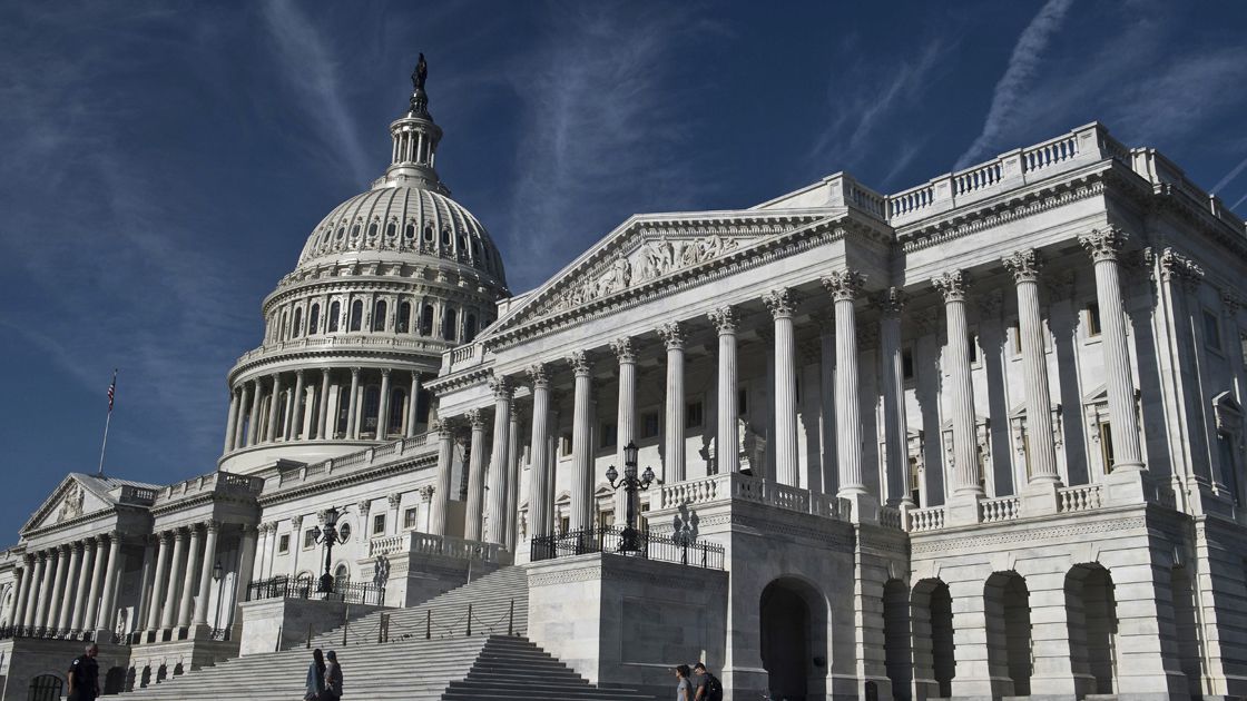 People walk past the US Capitol in Washington, DC, on July 31, 2017.