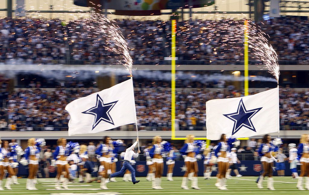 Dallas Cowboys flag runners run with the flags during the game