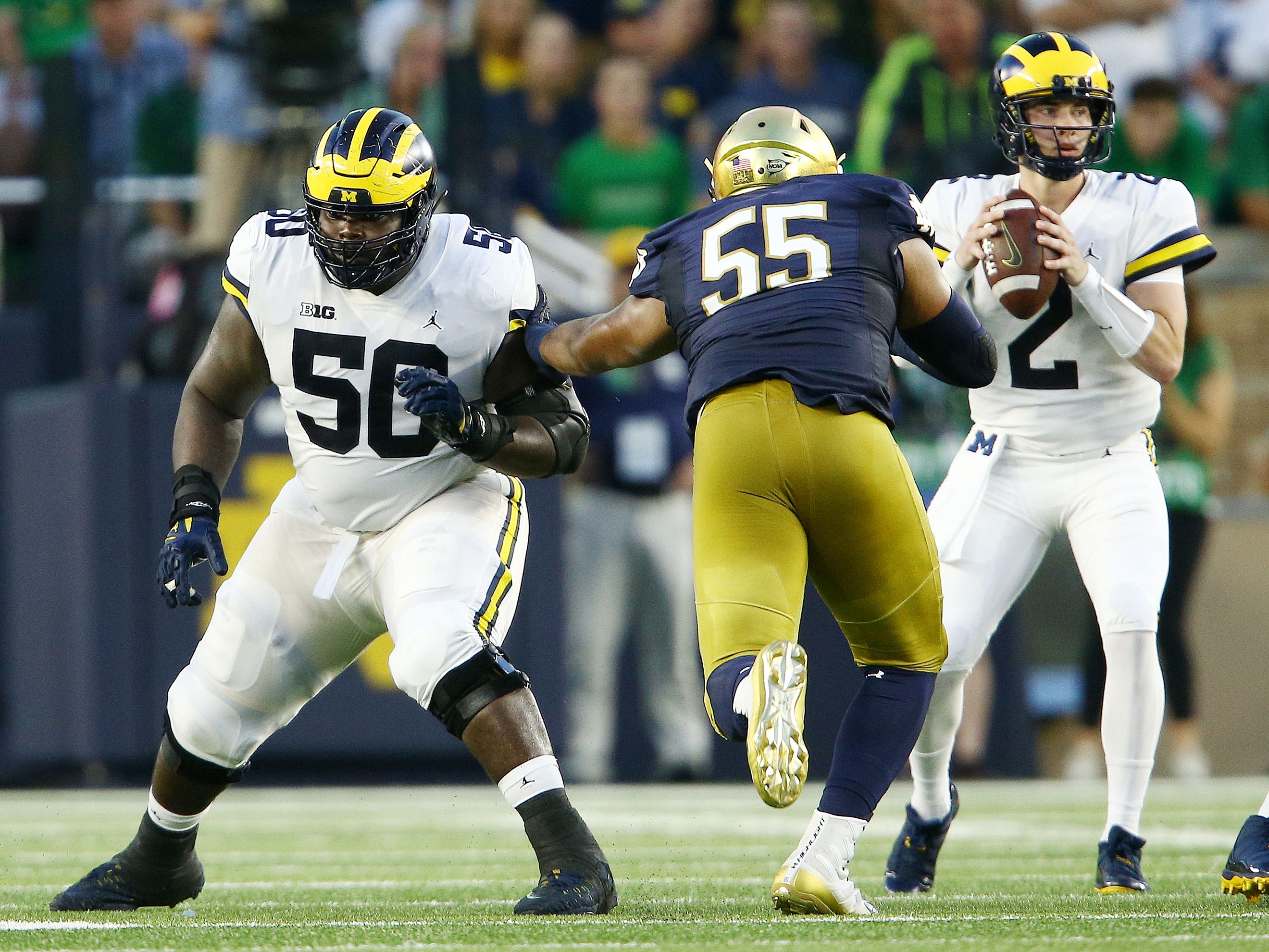 Michigan OL Michael Onwenu in better shape, 'like running through a brick  wall' 