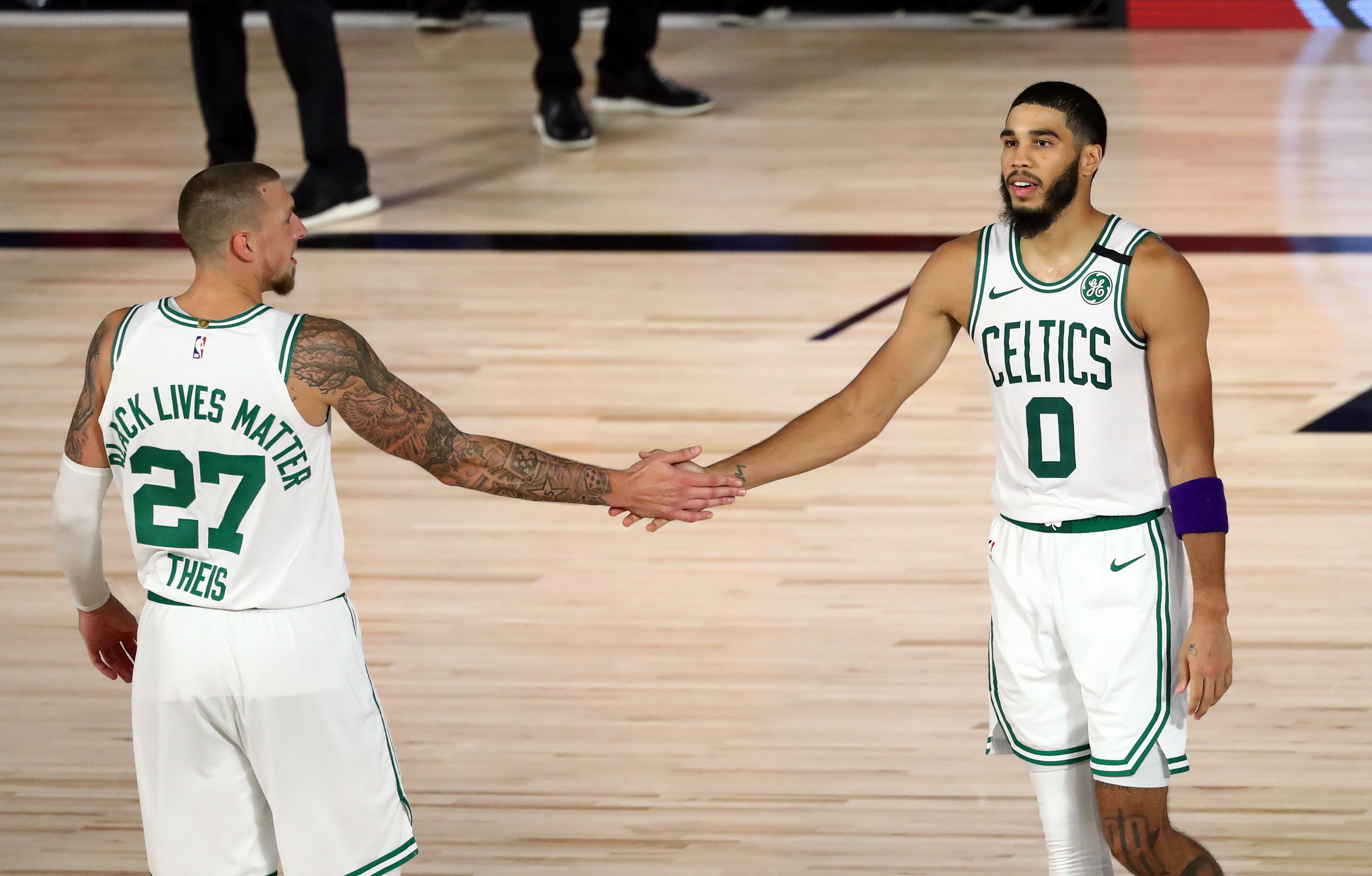 Boston Celtics forward Jayson Tatum (0) wears a purple armband to honor the  late Kobe Bryant during the second half of Game 4 of an NBA basketball  first-round playoff series against the