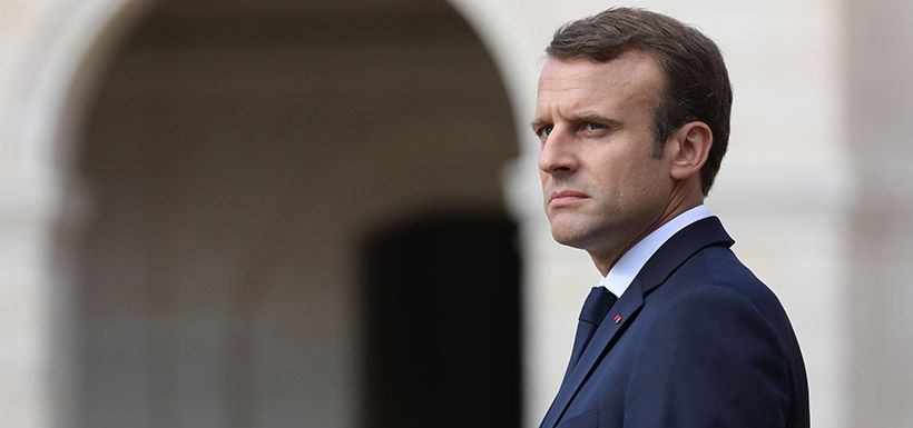 French President Emmanuel Macron looks on during a ceremony in tribut