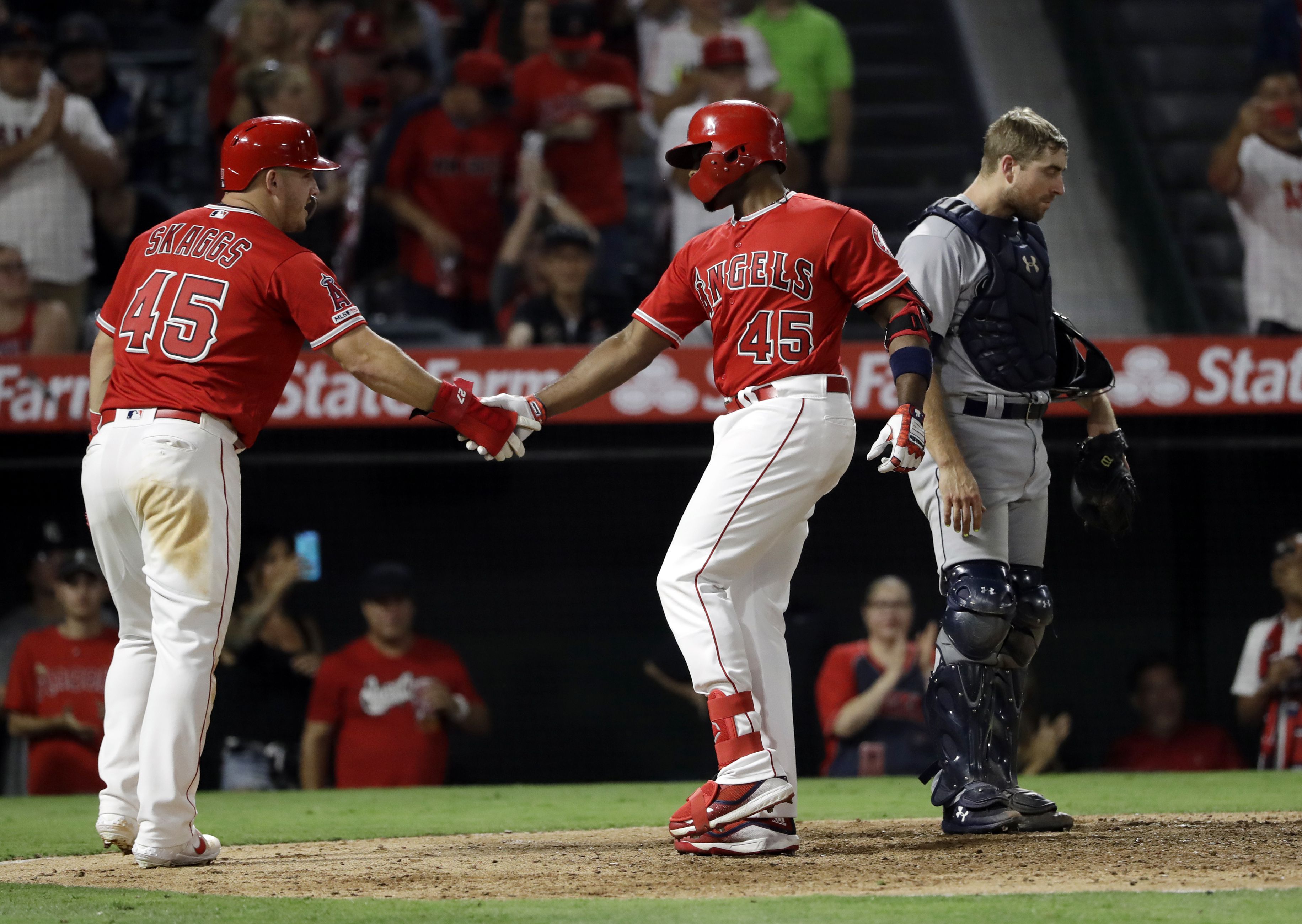 Members of the Los Angeles Angels place their jerseys with No. 45 in honor  of pitcher Tyler Skaggs on the mound after a combined no-hitter against the  Seattle Mariners during a baseball