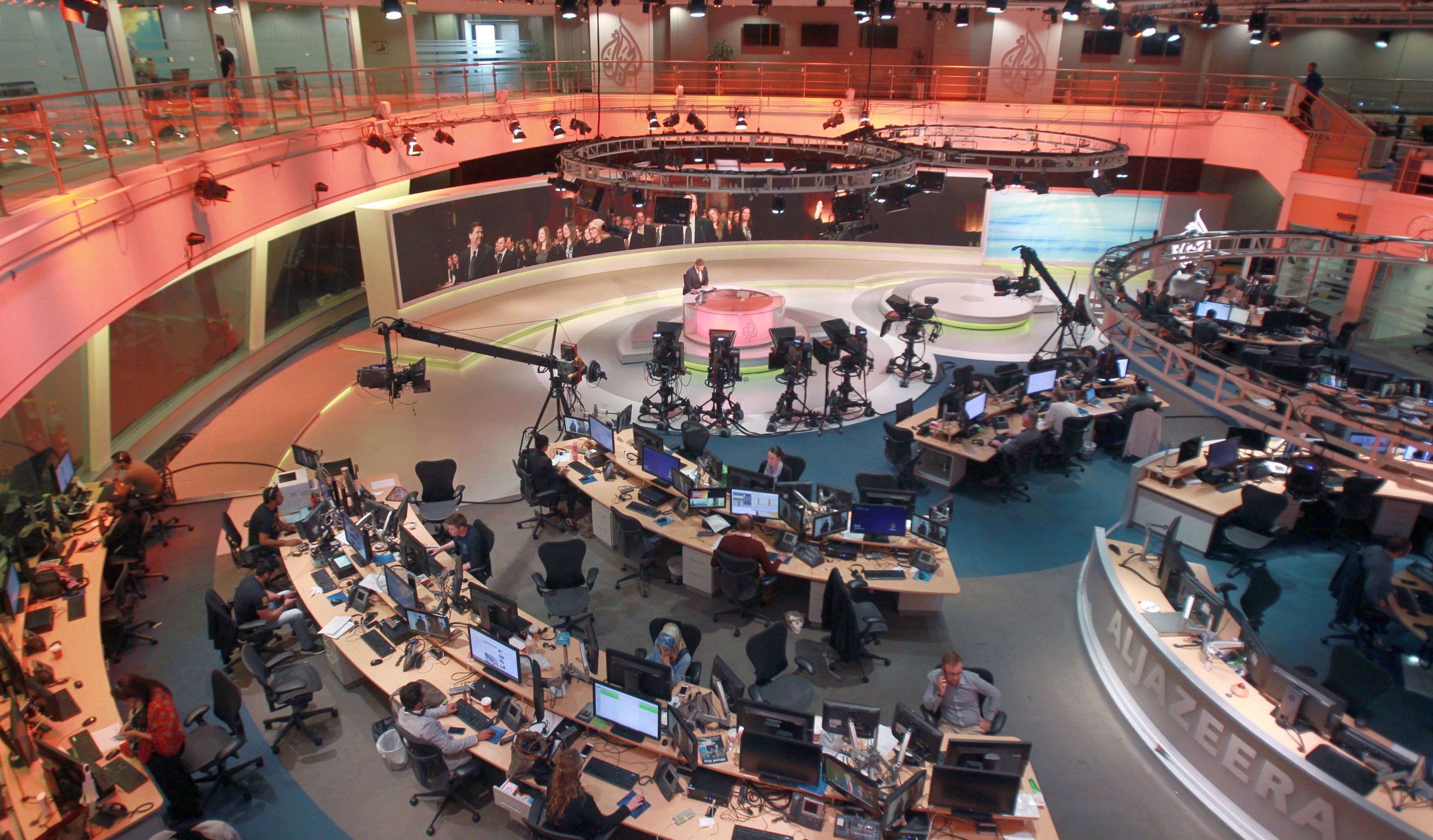 Staff work inside the Al Jazeera Network HQ in Doha