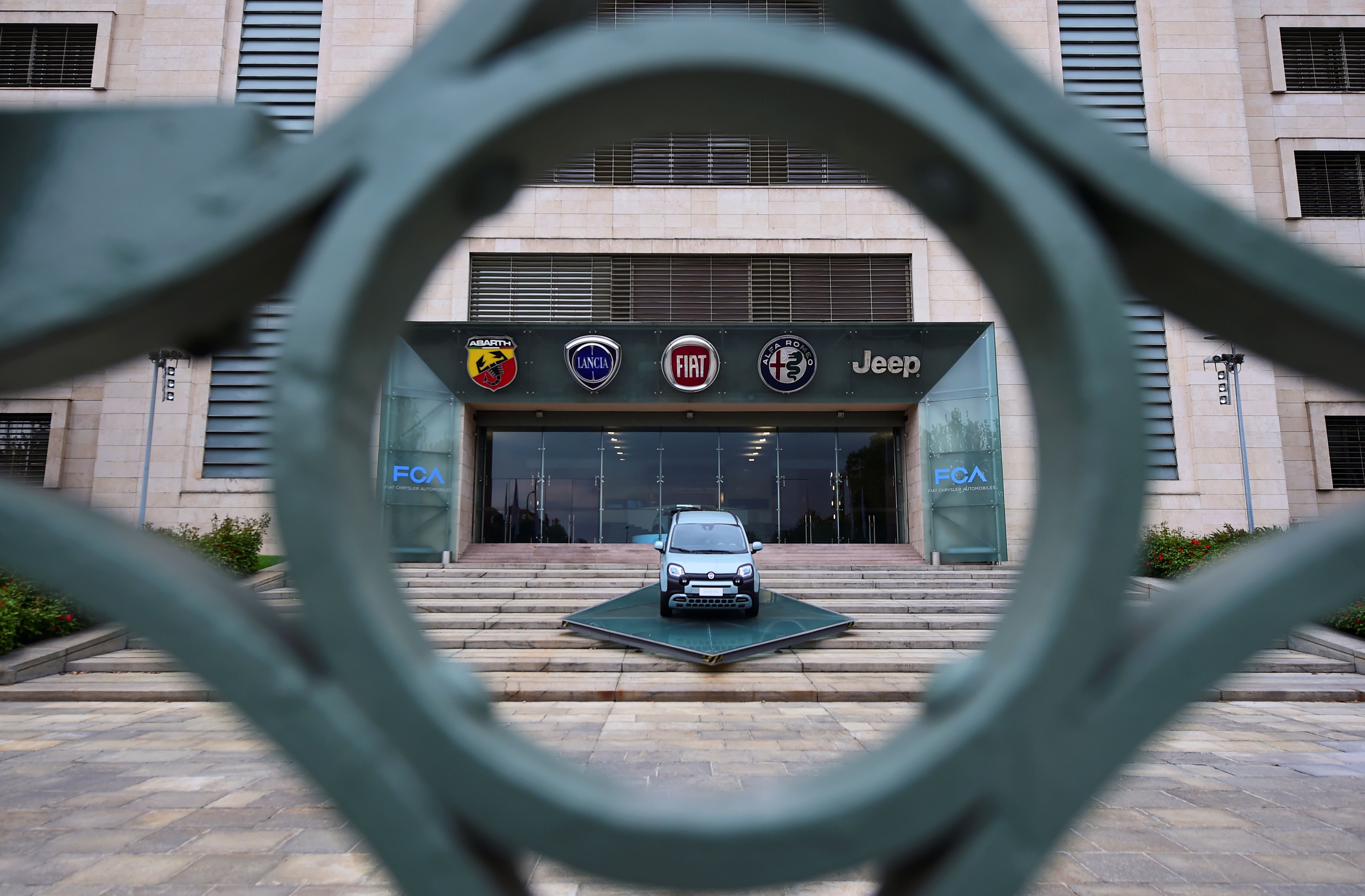 FILE PHOTO: A car is displayed at the entrance of the FCA Italy headquarters in Turin