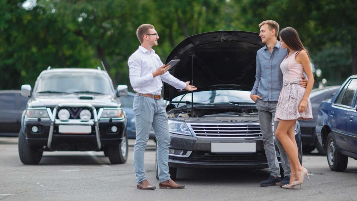 young-couple-buying-used-car-1068x600