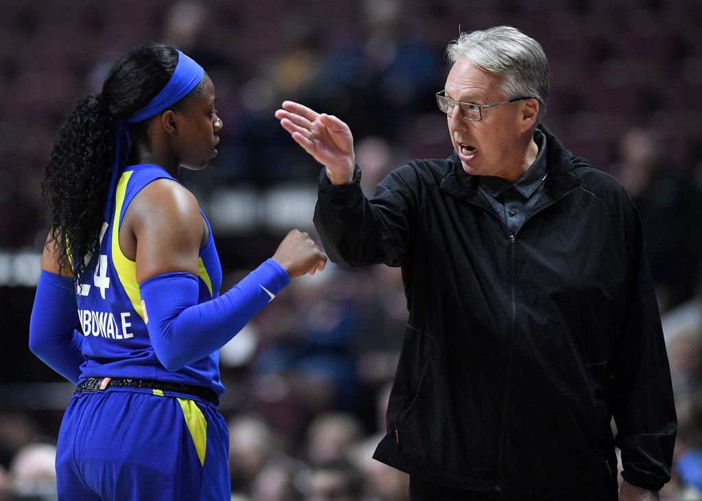 ATLANTA, GA – MAY 24: Dallas head coach Brian Agler (left) gathers his team  together in a time-out during the WNBA game between the Atlanta Dream and  the Dallas Wings on May
