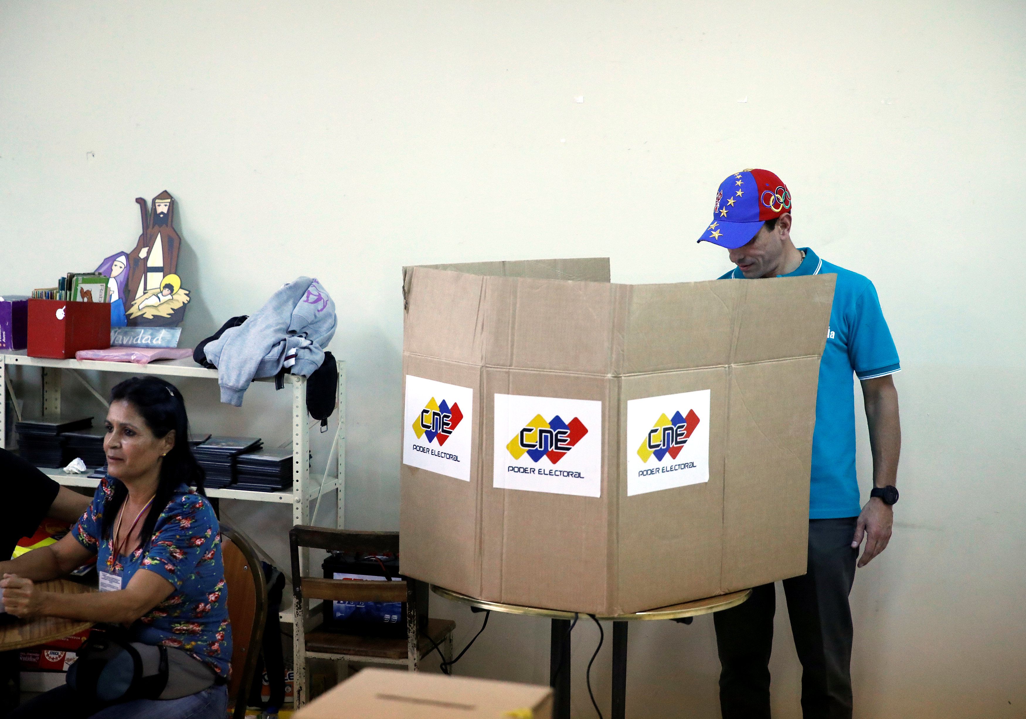 Venezuela's opposition leader Henrique Capriles casts his vote on a polling station during a nationwide elections for new governors in Caracas