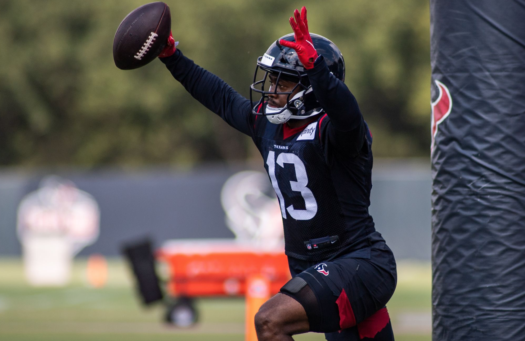 Houston Texans wide receiver Brandin Cooks (13) is flipped upside