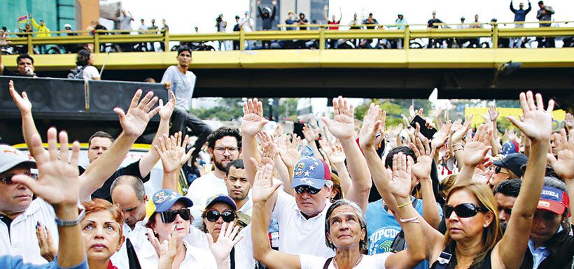 people-hold-their-hands-up-in-prayer-during-37664572