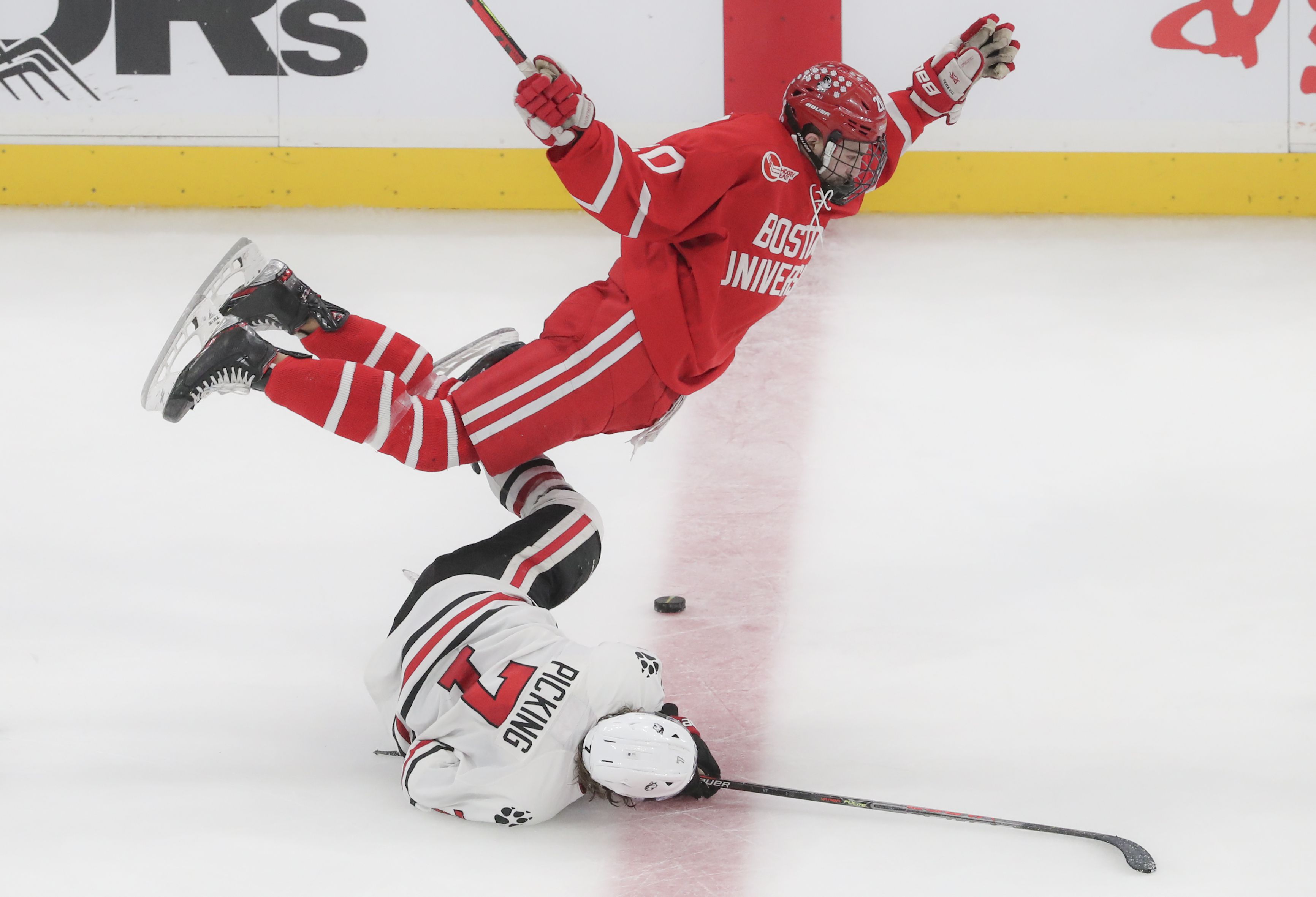 Boston University's Trevor Zegras (13) celebrates his goal as Northeastern  players look on during the first period of the Beanpot Tournament  championship NCAA college hockey game in Boston, Monday, Feb. 10, 2020. (
