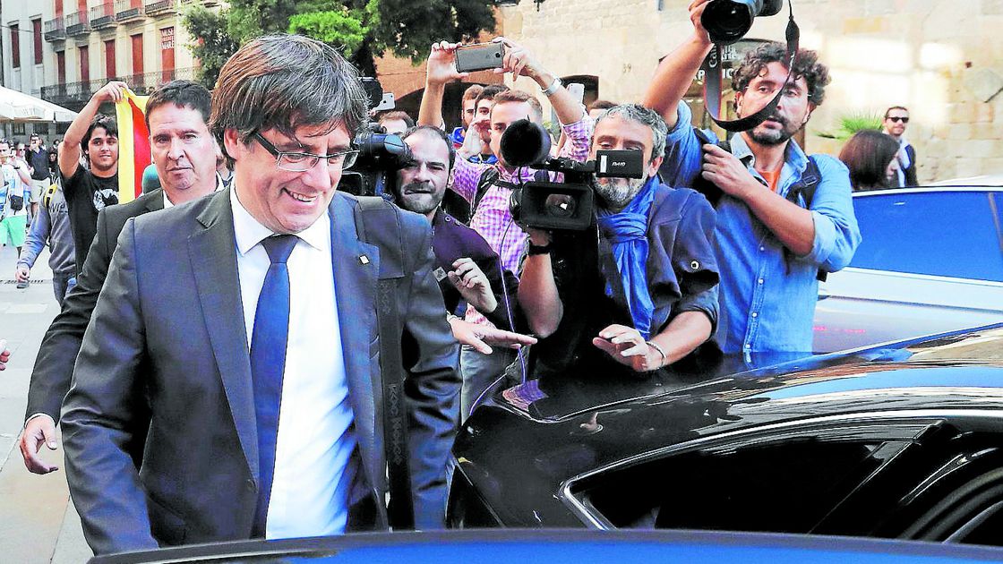 Catalan President Puigdemont leaves the regional government headquarters after delivering a statement in Barcelona