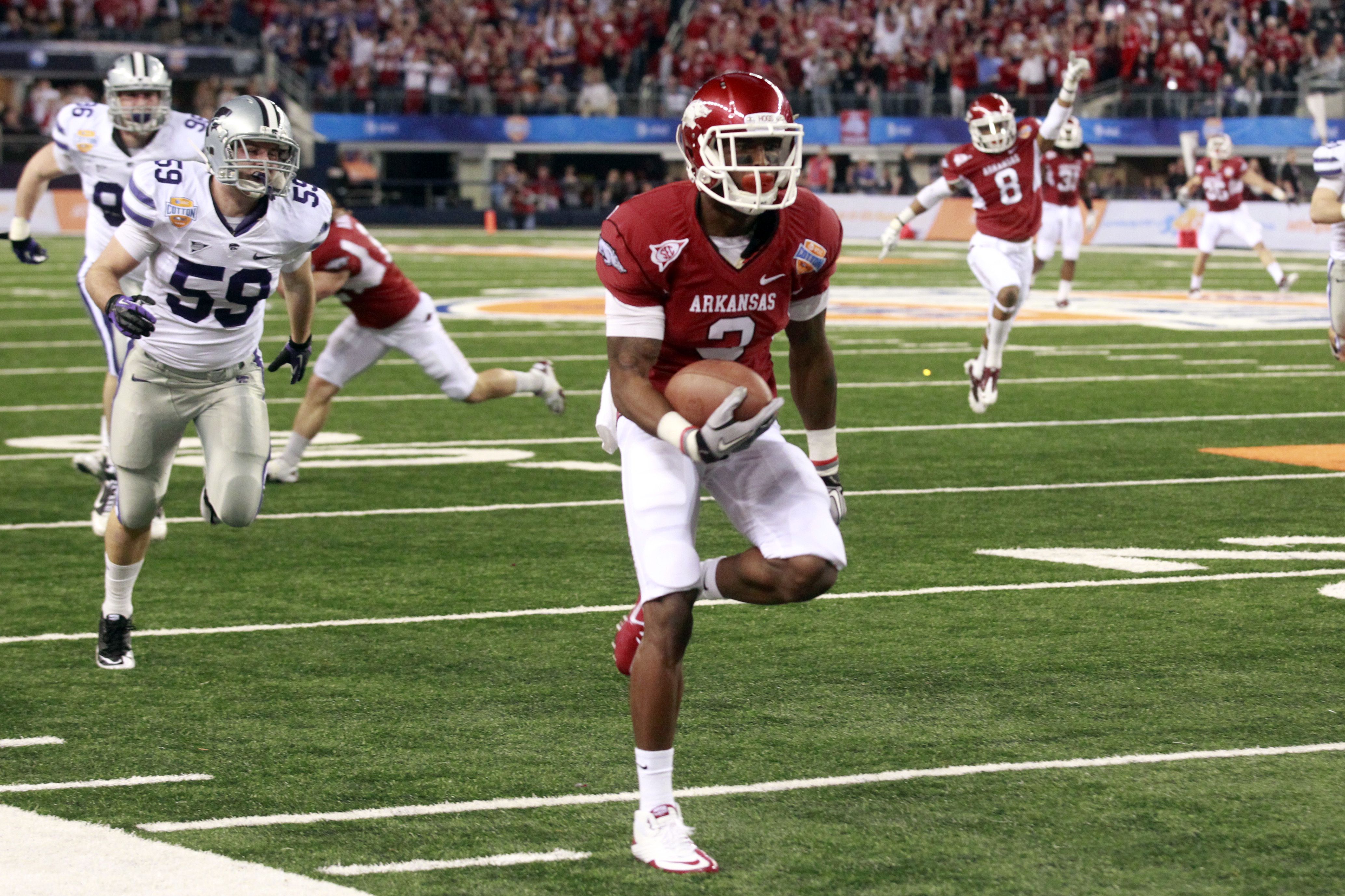 Andre McDonald (18) of Kansas State pulls in a touchdown pass late the  first half as Jake Bequette of Arkansas defends in the Cotton Bowl at  Cowboys Stadium in Arlington, Texas, on