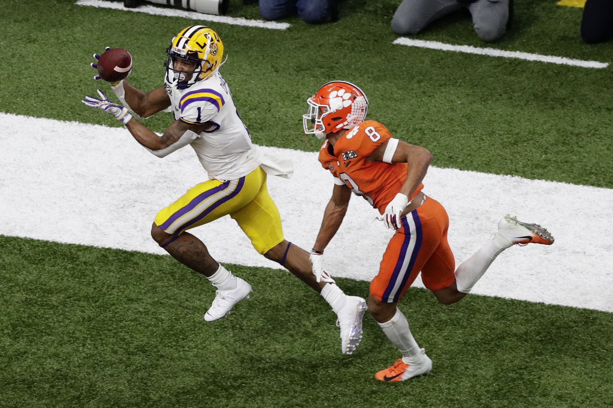 LSU's quarterback Joe Burrow runs for 29 yards to set up a touchdown in  second quarter of the college national championship game against Clemson at  the Superdome in New Orleans, Louisiana on