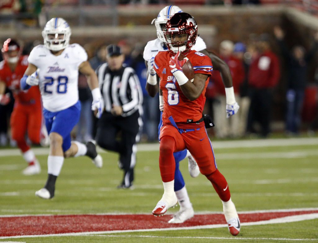 Eric Dickerson of the SMU Mustangs carries the ball during a game