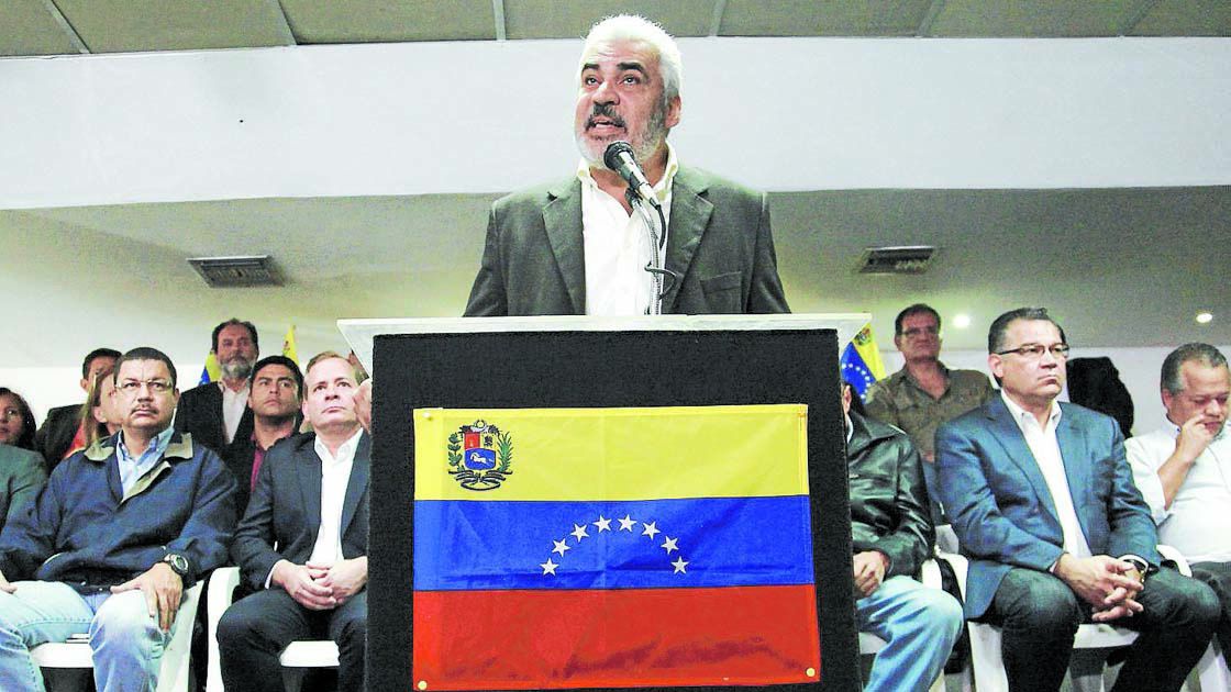 Angel Oropeza, member of the Venezuelan coalition of opposition parties (MUD), talks to the media during a news conference in Caracas