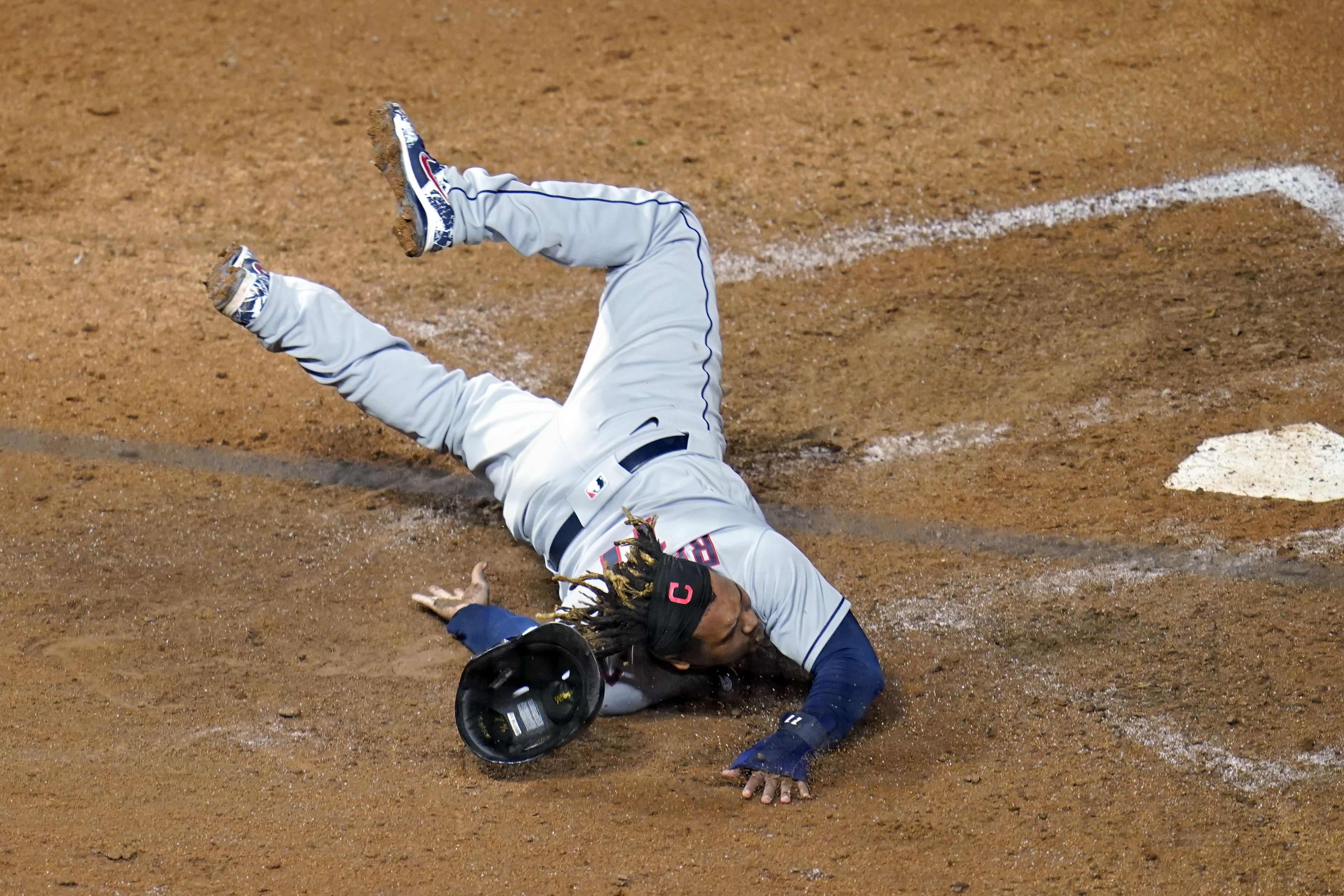 Cleveland Indians' Jose Ramirez, right, runs home to score in