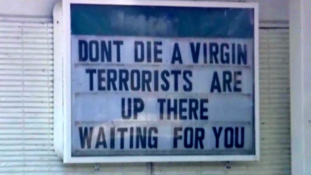 Gas station sign beginning with “don't die a virgin” drawing attention 